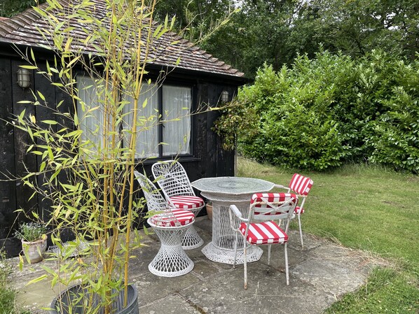 Cabin patio in secluded garden surrounded by forest and countryside