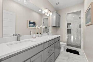 Dual vanity master bathroom with tub and walk-in shower