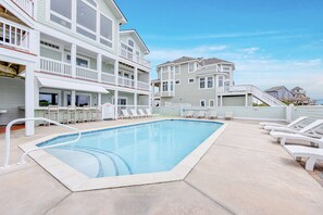 The sandy beach beckons beyond the dunes, but you may find the most desirable waterfront location is the private pool.