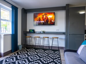 Whether you're lounging with friends or catching up on your favorite series, our living room with sleek design and contemporary furnishings and a flat-screen TV offers the perfect setting for relaxation and entertainment.