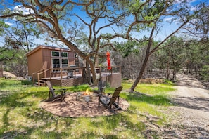 View of the cabin and fire pit area.