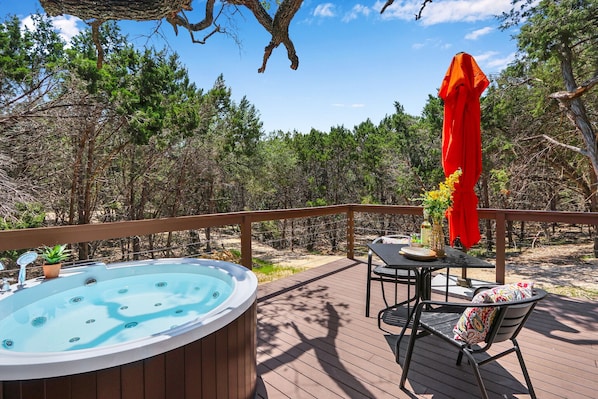 Outdoor jetted bathtub on the deck. Hill country views in the daytime and stargazing at night.