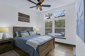 View of the queen bed from the entrance to the bathroom.