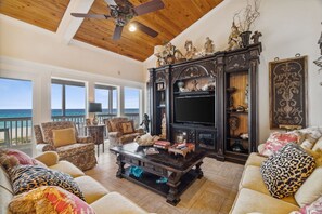 Enjoy the beautifully decorated living area with floor-to-ceiling views of the sugar white sands and emerald green waters.