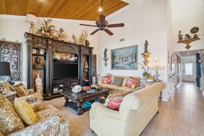 This luxurious condominium features vaulted pecky cypress ceilings, high-end decor, and designer lighting.