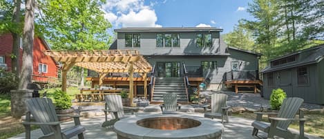 Lakefront home with built-in fire pit and spacious deck.