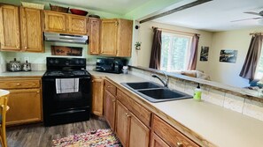 Full kitchen with everything you need and it looks into the living room