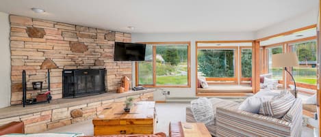 Living room with wood burning fireplace and views of the lake.