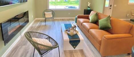 Living room with huge a window view : school baseball field 