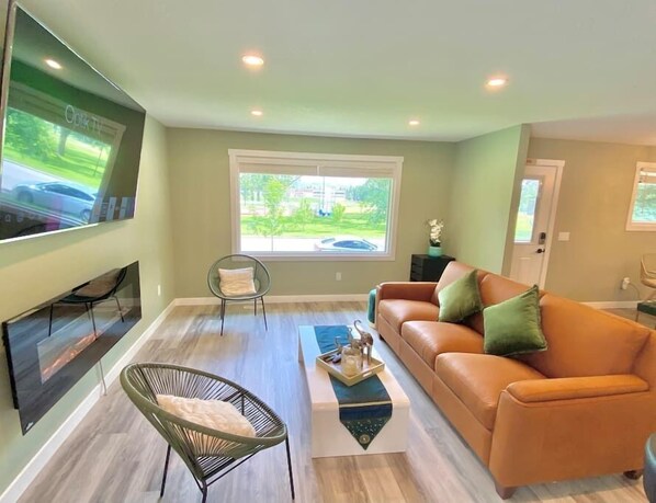 Living room with huge a window view : school baseball field 