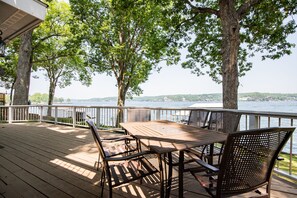 Wraparound deck with dining areas and lake views