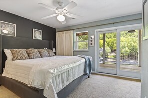 Plush Bed, An Outside View and A Private Deck Access Bring the Best Comfort in the Master Bedroom