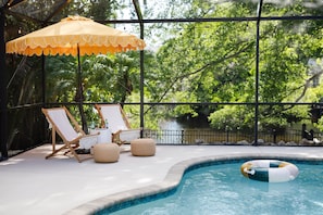 Kick back and unwind by our private pool, with an immediate view of the neighboring lake