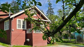 The heritage cottage surrounded by fruit trees.