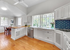 Kitchen with corian benchtop. Double fridge with extra fridge on verandah.