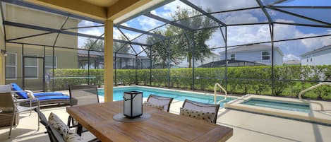 The spacious lanai and pool area is a stunning retreat that seamlessly blends indoor and outdoor living