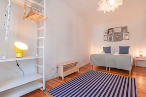 Bedroom 1 with a queen-sized bed, bedside tables, and a hanger rack for your convenience. #bedroom #comfort #cozy #home