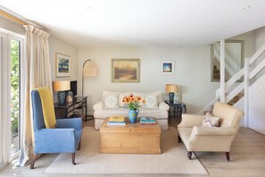 Living room area with sofa and two arm chairs 