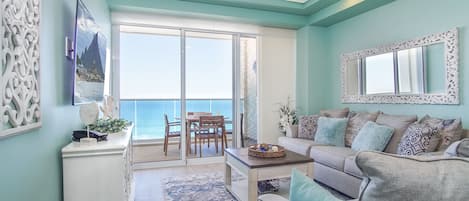 The charming living room overlooks the beach below.