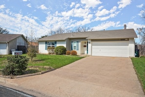 Curbside view on a quiet street in a quaint, residential neighborhood community.
