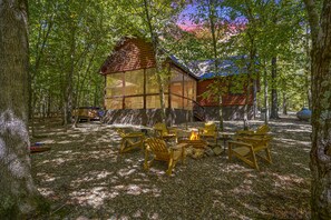 The glass sunroom is showcases the oversized lot and all the tall timbers.