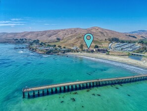 Take a leisurely stroll along the sandy beach, immersing yourself in the coastal charm of this prime locale.
