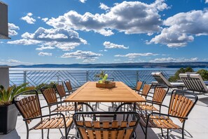 Dining table with chairs on the spacious terrace of a Croatian private villa for rent in Omiš