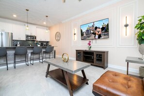 Step into this spacious, comfortable living area. The expansive room is adorned with tasteful decor, offering a blend of modern aesthetics and homey warmth. 
