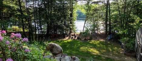 Large flat fenced in backyard with views of the lake.