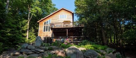 Chalet sits perched on the ridge with dramatic views of the lake and backyard