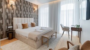 Modern bedroom with TV, small desk, comfortable chair, ample natural light, and balcony access for a serene and functional retreat.
#relax #bedroom
