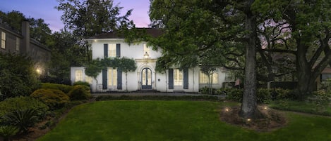 With impressive stonework, a grand wrought iron door, and lush ivy surrounding the entrance, this upscale mansion is a truly enchanting and regal retreat.