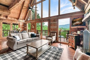 Spacious family room offers couches, coffee table, dining table, and easy access to the kitchen