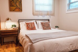 A serene blend of white elegance and warm wood tones, where comfort meets timeless style.