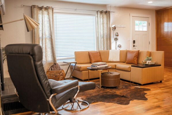 Elegant warmth meets timeless charm, a classic wood-accented living room designed for comfort and sophistication.