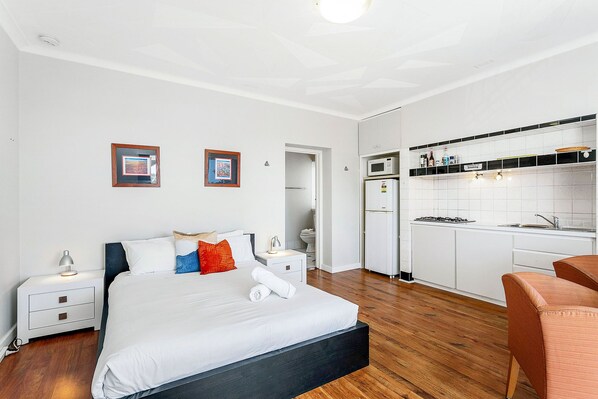 This spacious and well-lit queen bed offers a comfortable retreat after a day of exploring.