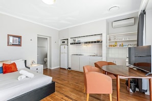 This open-plan studio offers a comfortable and convenient living space, with a well-equipped kitchenette and a cozy seating area.