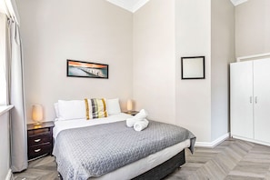 Unwind in this cozy queen bed, featuring a comfortable bed and plush linens.