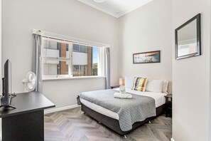 Retreat to this serene queen bed, featuring a comfortable bed and a view that will inspire your dreams.