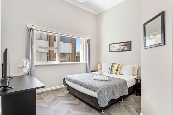 Retreat to this serene queen bed, featuring a comfortable bed and a view that will inspire your dreams.