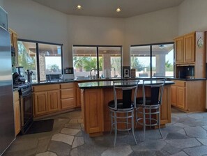Spacious, well-equipped kitchen with tremendous counters and passthrough windows