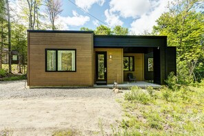 Front view of the house with long driveway for cars