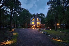 House view in night with long driveway and lights
