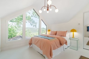 Upstairs bedroom with a Queen bed, closet, and views for miles.