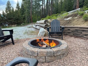 Relax by the fire pit under starry skies at our cozy cabin retreat.