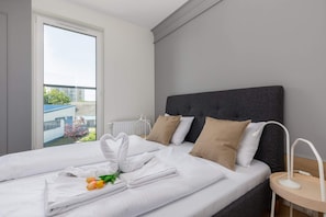 Cozy bedroom with a double bed and minimalistic decor.