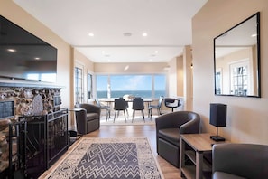 Living area with fireplace near the dining area with stunning view