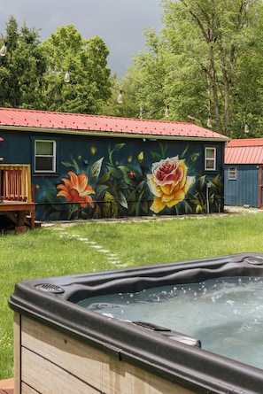 Soak under the open sky in your private hot tub, tucked into the backyard and surrounded by nature. Serenity and relaxation come easy in this peaceful retreat.