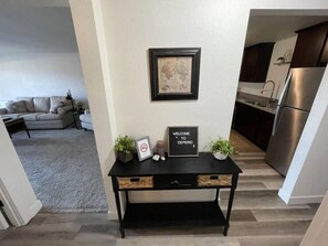 View from Bathroom Area into Entryway and Kitchen