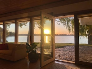 A lake sunset view from the livingroom, patio or 4 seasons porch.